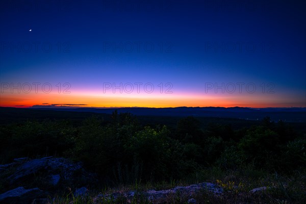 Sun sets behind the Catskills Mountains