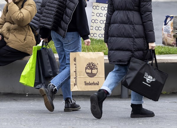 Consumer tourist lugging shopping bags