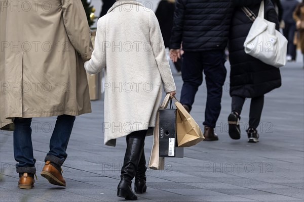 Consumer tourist lugging shopping bags