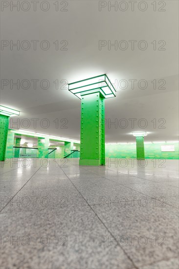 Modern underground station with green columns and perspective view