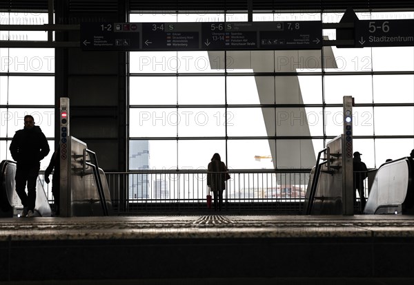 A woman waiting for a train on the platform at Ostkreuz station