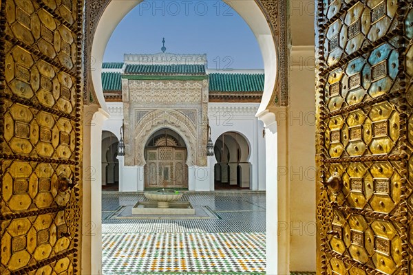 Main entrance with bronze doors and courtyard of the al-Qarawiyyin Mosque and university in the old medina of the city Fes