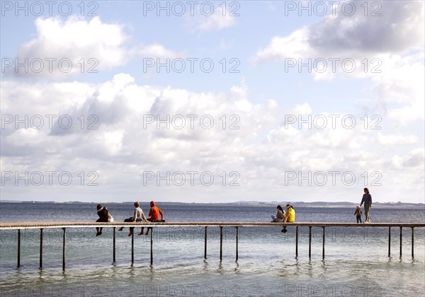 People walking on the infinite bridge . The bridge is a work of art built for Sculpture by the Sea