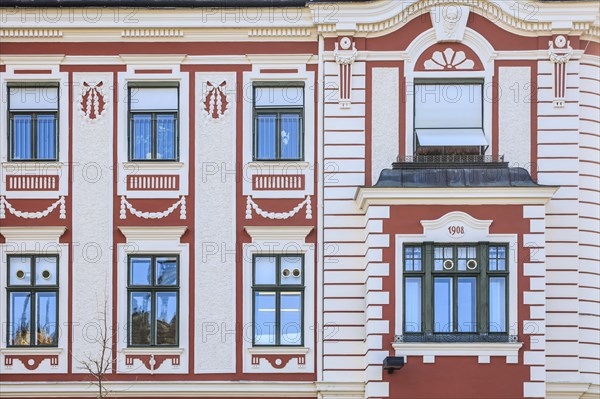 Red and white painted facade of an Art Nouveau house from 1908 on Dreifaltigkeitsplatz