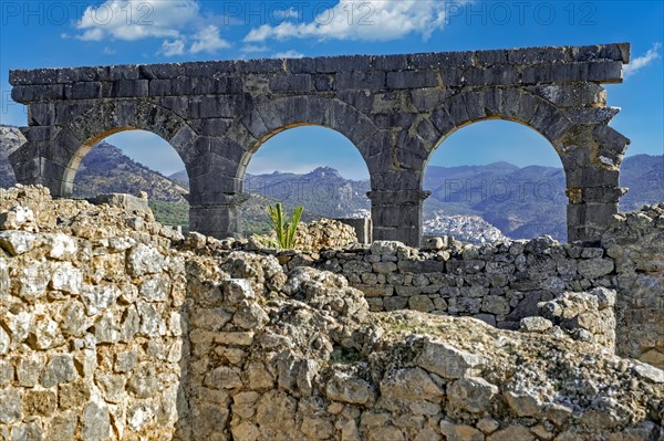 Rif Mountains seen through arches of the North Baths ruins at Volubilis