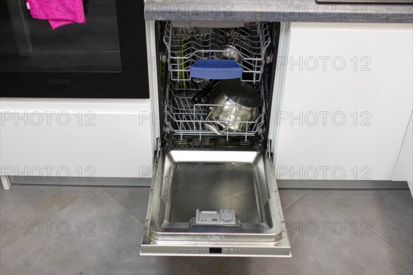 White modern dishwasher in the interior of a white kitchen