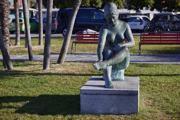 Sculpture of a seated female nude by sculptor Werner J. Mueller on the lakeside promenade of Lake Maggiore in Ascona