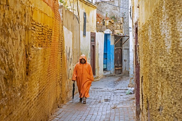 Muslim man wearing orange djellaba