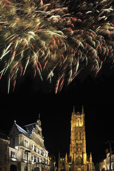 Colourful fireworks above the Saint Bavo's Square with theatre and the Saint Bavo's cathedral at night