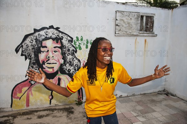 Tour guide Susan Maxwell in front of Bob Marley mural