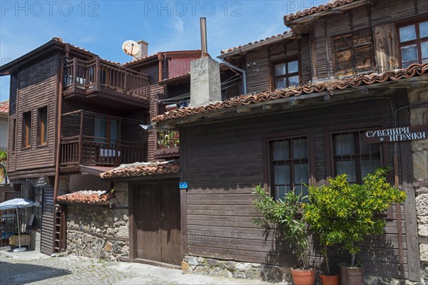 Traditional wooden houses with balconies under a blue sky