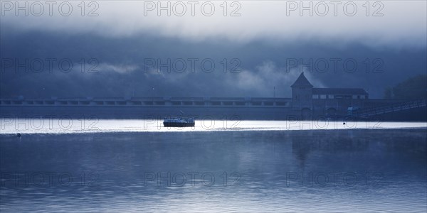 Eder dam with dam wall and pleasure boats on the Edersee in the early morning