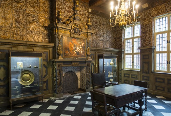 Gold leather hangings and panelling of 17th century town hall treasury at STAM