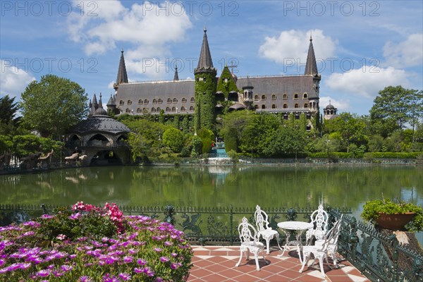 An idyllic castle view with a pond in the foreground