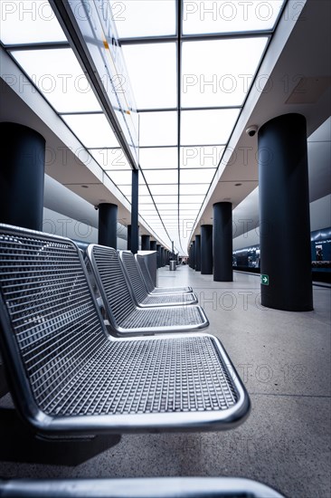 Interior public transport waiting area with benches and modern architecture