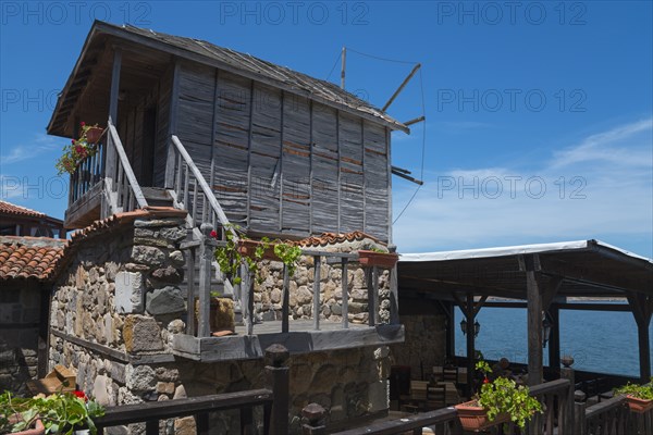 Rustic wooden windmill overlooking the sea