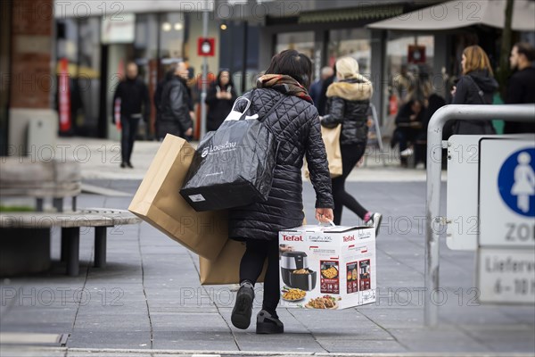 Consumer tourist lugging shopping bags