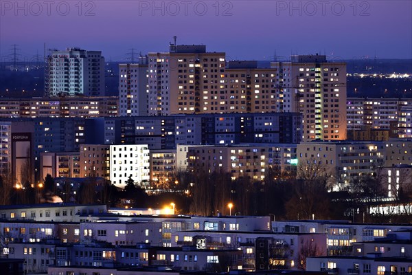 View in the evening at blue hour of high-rise buildings and apartment blocks with rental flats and condominiums in the Berlin district of Marzahn-Hellersdorf