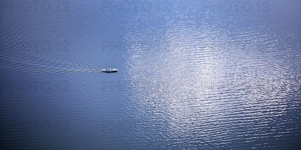 Elevated view of a leisure boat on the Edersee with cloud reflection on the water surface