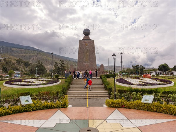 Tourists in front of the equator monument Ciudad Mitad del Mundo