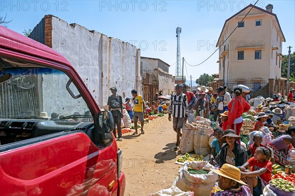 Malagasy vendors selling fruit and vegetables at food market in the streets of city Ambalavao
