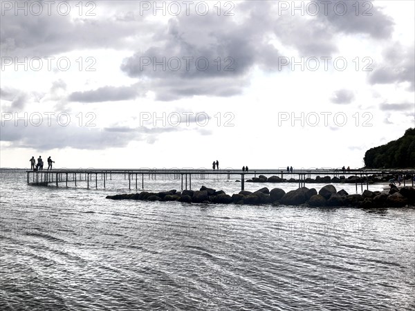 People walking on the infinite bridge . The bridge is a work of art built for Sculpture by the Sea