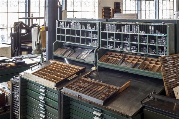 Type case in composing room at printing business