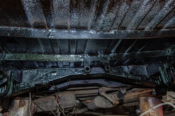 Treated underside of the car with an anti-corrosion solution with a sealant