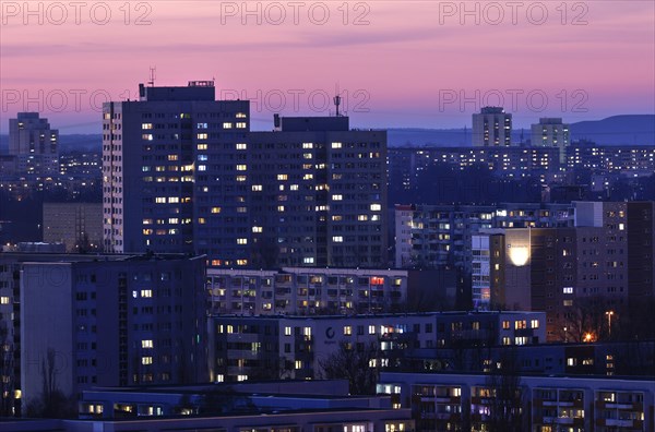 View in the evening at blue hour of high-rise buildings and apartment blocks with rental flats and condominiums in the Berlin district of Marzahn-Hellersdorf