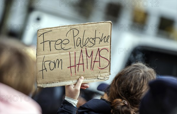 A participant in the demonstration Solidarity March with Israel shows a poster with the inscription Free Palestine from Hamas