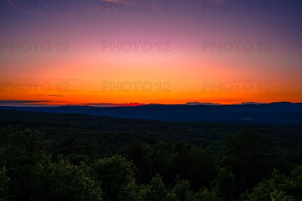 Sun sets behind the Catskills Mountains