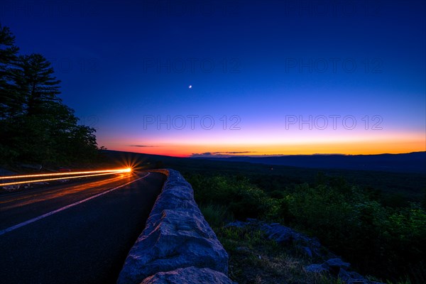 Sun sets behind the Catskills Mountains