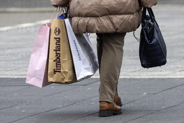 Consumer tourist lugging shopping bags