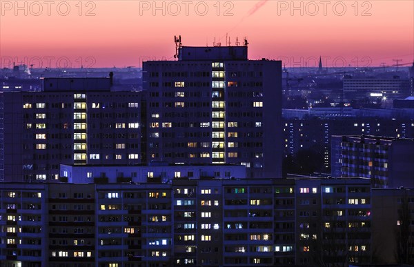 View in the evening at blue hour of high-rise buildings and apartment blocks with rental flats and condominiums in the Berlin district of Marzahn-Hellersdorf