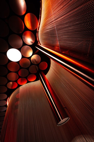 Close-up of a red light installation with spheres and reflections