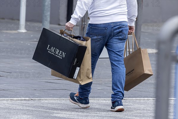 Consumer tourist lugging shopping bags