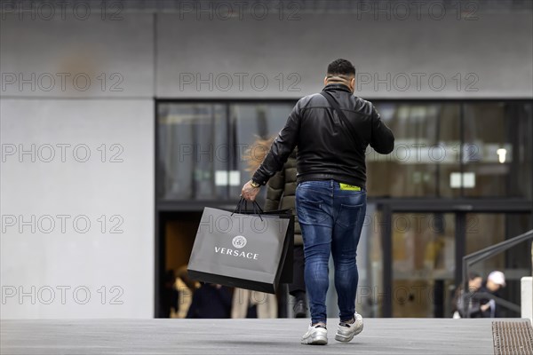 Consumer tourist lugging shopping bags