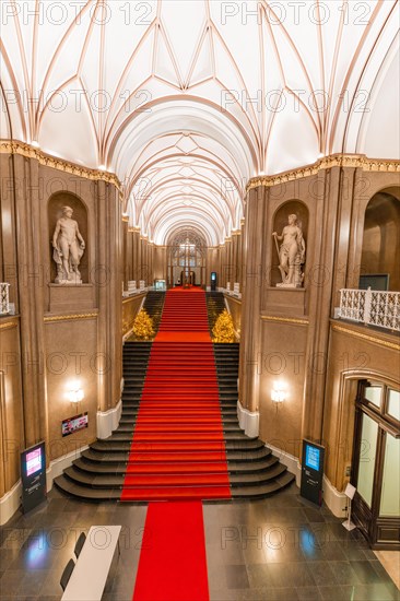 Interior of the Rotes Rathaus with red carpet and elegant staircase