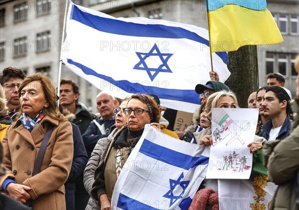 Participants in the march in solidarity with Israel display placards and Israeli flags