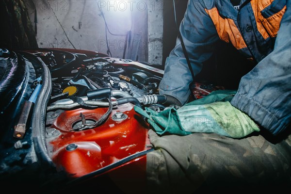 Car repair by an auto mechanic in a car service center
