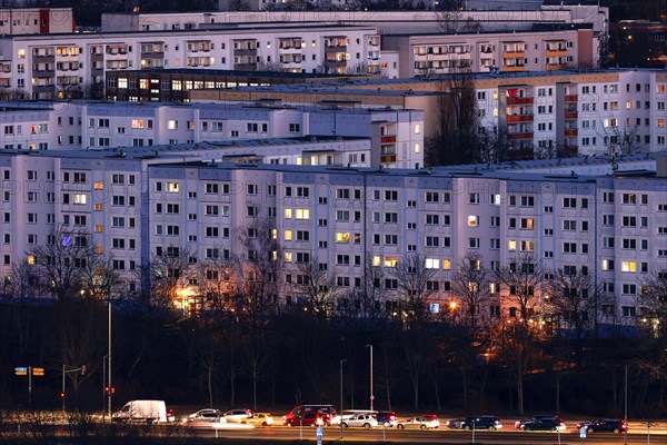 View in the evening at blue hour of high-rise buildings and apartment blocks with rental flats and condominiums in the Berlin district of Marzahn-Hellersdorf