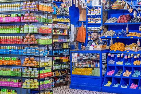 Moroccan vendor of soap in beauty shop selling cosmetics in medina