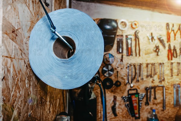 Auto mechanic tools and paper towels hanging on the wall in a car service center