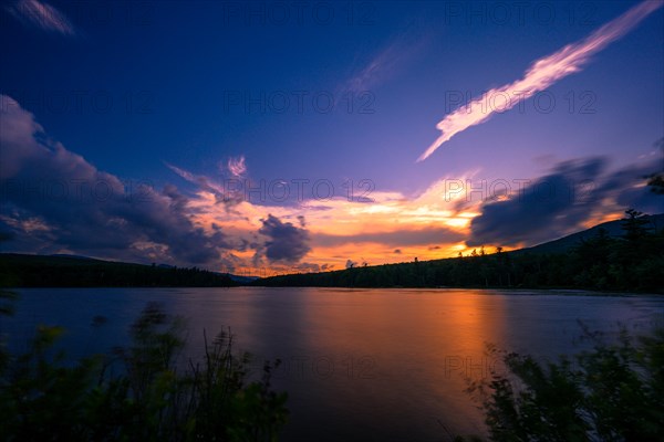 Summer Solstice Sunset on a lake in Catskills Mountains