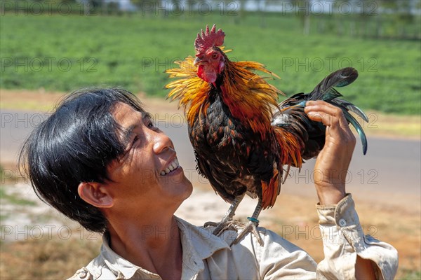 Man with cock on shoulder