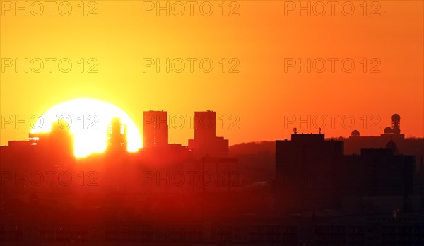 View during sunset of high-rise buildings at Potsdamer Platz and the former listening station at Teufelsberg