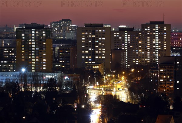 View in the evening at blue hour of high-rise buildings and apartment blocks with rental flats and condominiums in the Berlin district of Marzahn-Hellersdorf