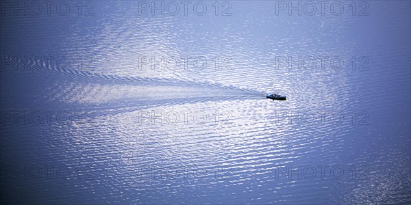 Elevated view of a leisure boat on the Edersee with cloud reflection on the water surface