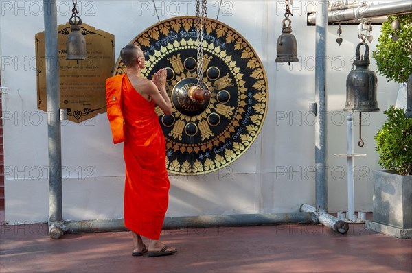 Monk in front of a ritual gong