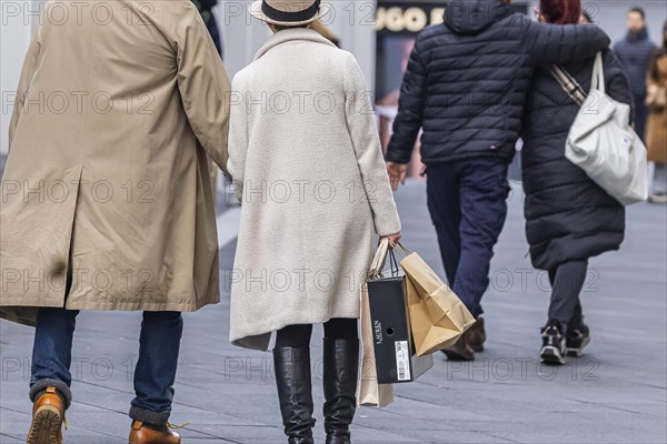 Consumer tourist lugging shopping bags